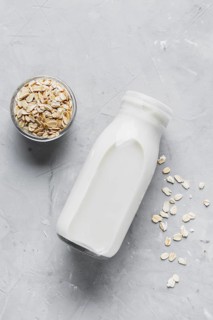 Flat lay milk bottle with oats