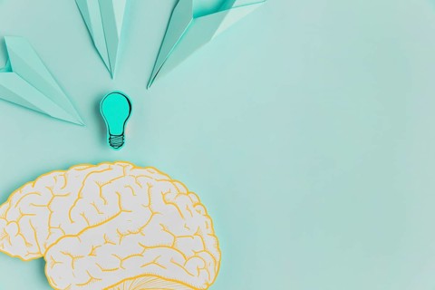 Paper airplanes pointing brain with copy space