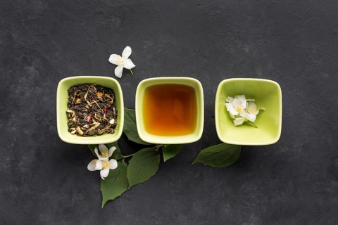 Row healthy tea ingredient white jasmine flower black surface