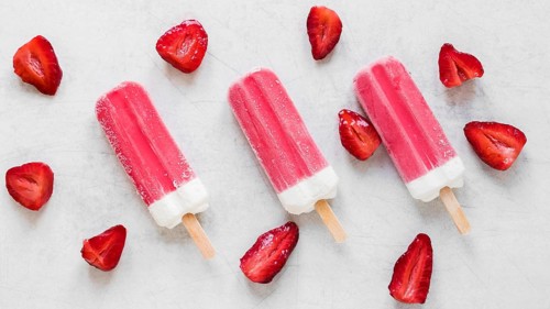 Top view yummy popsicles with strawberry