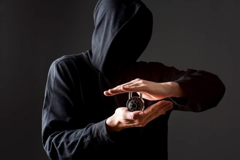 Front view hacker holding lock