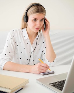 Online classes with student holding her headphones