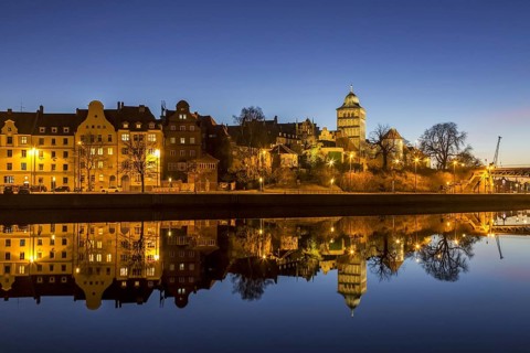 Gothic Burgtor Gate reflected in water of the Elbe Luebeck Canal