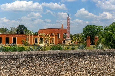 View from bus window of former henequen estate buildings of Hacienda Kinchil