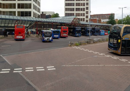 View through bus window of buses in bus station in the town centre