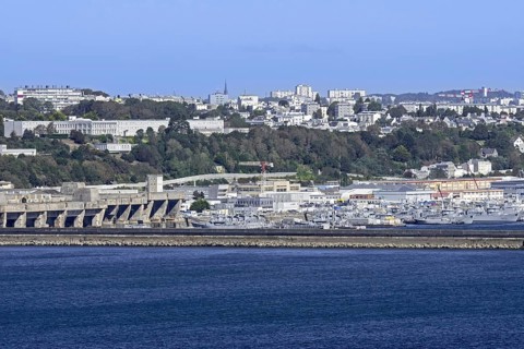 View over German WW2 U-boat submarine pen and French Navy ships docked in the port