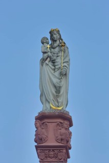 Madonna figure with baby Jesus and golden cross