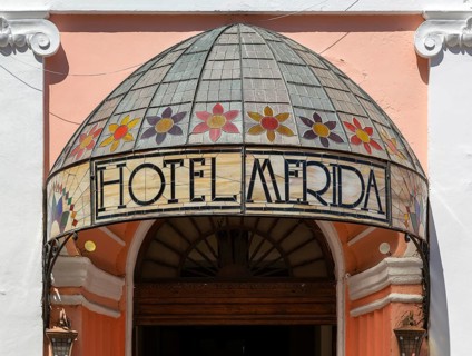 Stained glass canopy entrance to colonial style Hotel Merida