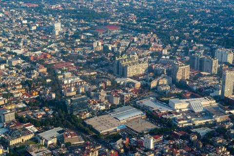 Oblique angle aerial view through plane window over Universidad district