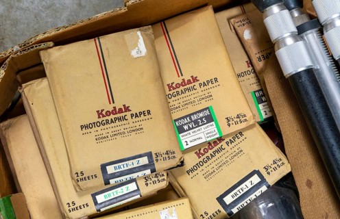 Old Kodak photographic paper packages on display in auction room