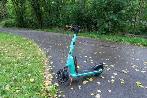 E-scooter of bike rental company TIER parked on pavement