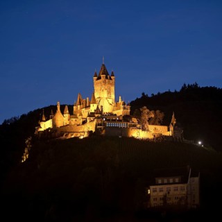 Illuminated Reichsburg Cochem in the evening