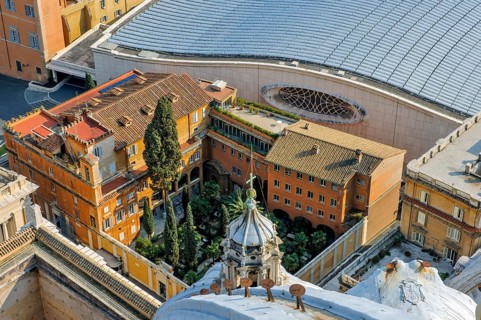 Bird's eye view of German cemetery in the Vatican next to St. Peter's Basilica in the background next to it roof of audience hall for audience with Pope