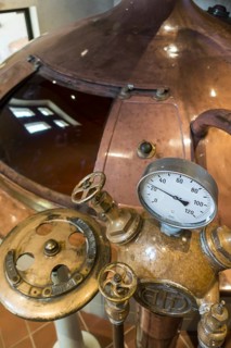 Gauge and valves on copper kettle of Trappist beer brewery in the Orval Abbey