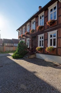 Half-timbered house decorated with flower boxes in the cobbled Lange Strasse in the Hanseatic town of Werben in the Altmark region. Werben