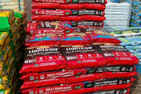 Bags of New Horizon all plant compost on sale in garden centre