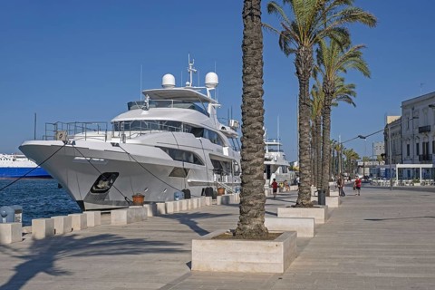 Promenade and motor yachts docked in the seaport