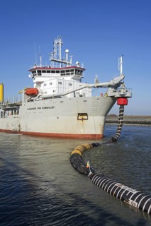 Trailing suction hopper dredger Alexander von Humboldt in port of Ostend discharging sand via long hoses