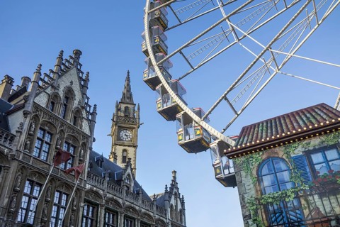 Old Post Office and Ferris wheel at Christmas market in winter in Ghent