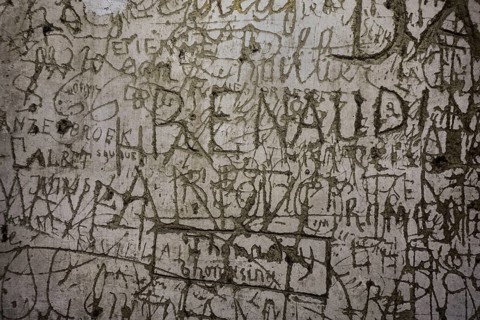 Old graffiti and scratchwork on wall inside the medieval Chateau de Bouillon Castle