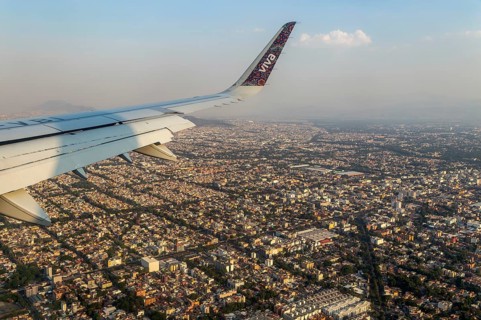 Oblique angle aerial view through plane window over Mexico City