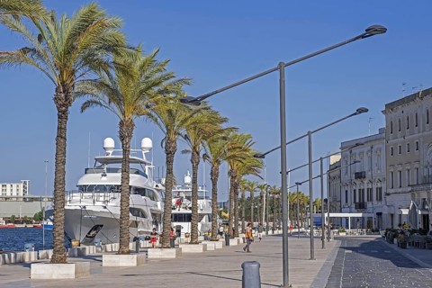 Promenade and motor yachts docked in the seaport