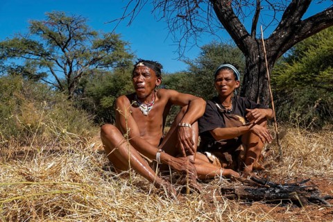 Bushman and San woman making fire in Kalahari