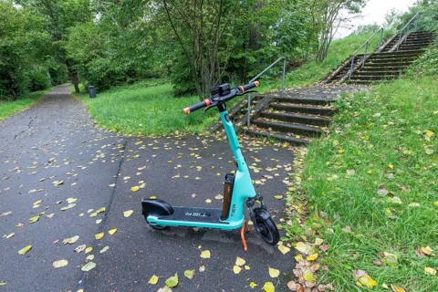 E-scooter of bike rental company TIER parked on pavement