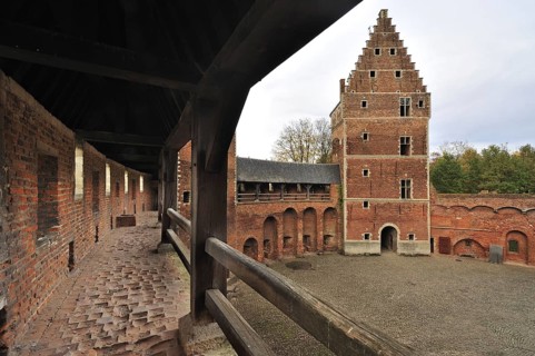 Worn-out red bricks in corridor and inner court of the medieval Beersel Castle