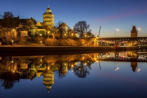 Gothic Burgtor Gate reflected in water of the Elbe Luebeck Canal