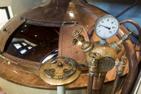Gauge and valves on copper kettle of Trappist beer brewery in the Orval Abbey
