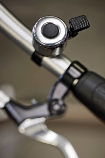 Close up of bike bell with external clapper mounted on the handlebars