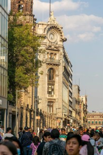 Crowd of people on pedestrianised street Avenida Madero