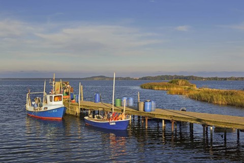 Fishing boats moored along wooden jetty at Neu Reddevitz