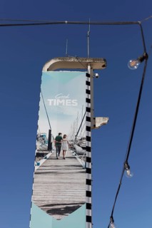 Advertising pillar Good Times with image of a holidaymaker couple