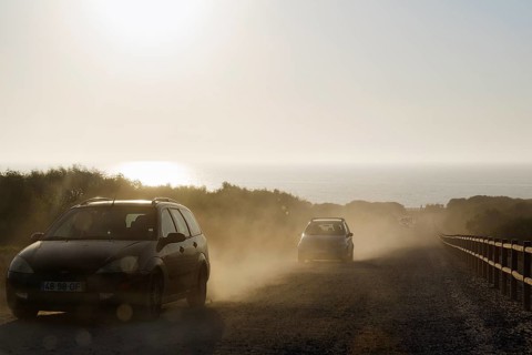Cars driving on dusty track
