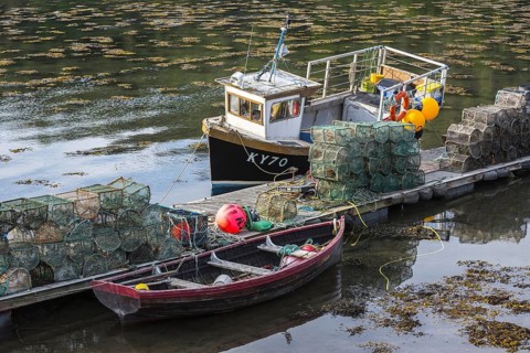 Moored small fishing boat and lobster pots