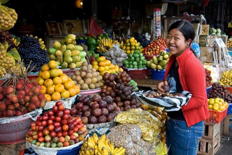 Exotic fruit market with laughing vendor