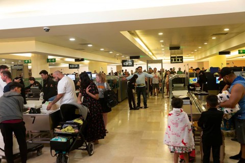 People passing through security check inside Cancun airport