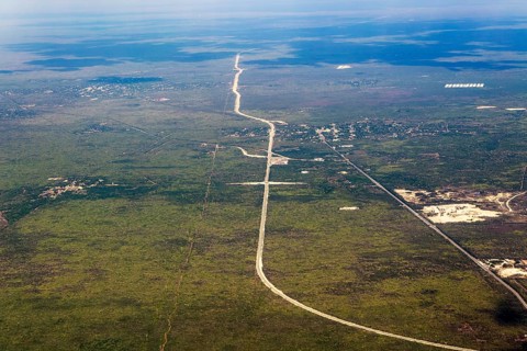 Oblique angle aerial view plane window over new railway tracks of Train Maya
