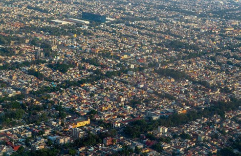 Oblique angle aerial view through plane window over Mexico City
