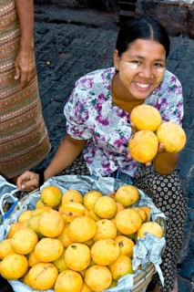 Woman selling mangoes at market