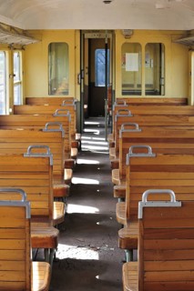 Old passenger carriage with wooden benches at the depot of the Chemin de Fer a Vapeur des Trois Vallees at Mariembourg