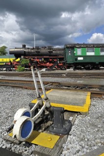 Steam train and track switch levers at the depot of the Chemin de Fer a Vapeur des Trois Vallees at Mariembourg