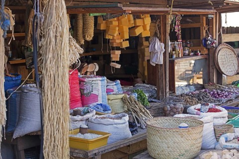 Food and groceries for sale in market stall at the weekly market in the city Ambalavao