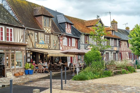 Half-timbered houses and cafes in one of the most beautiful villages in France Beuvron-en-Auge