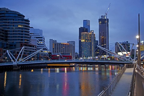 Bridge over the Yarra River and skyline with skyscrapers of the Melbourne City Centre at sunset