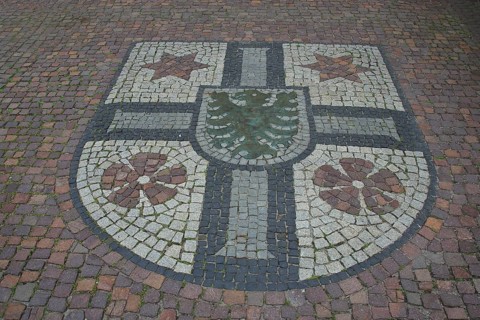 City coat of arms as a floor mosaic in front of the town hall