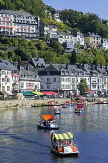 Paddle boats with tourists on the Semois river in the city Bouillon in summer