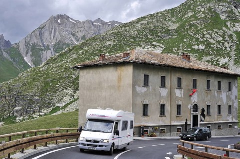 Tourist cars driving past the hospice Fonteinte at the Great Saint Bernard Pass